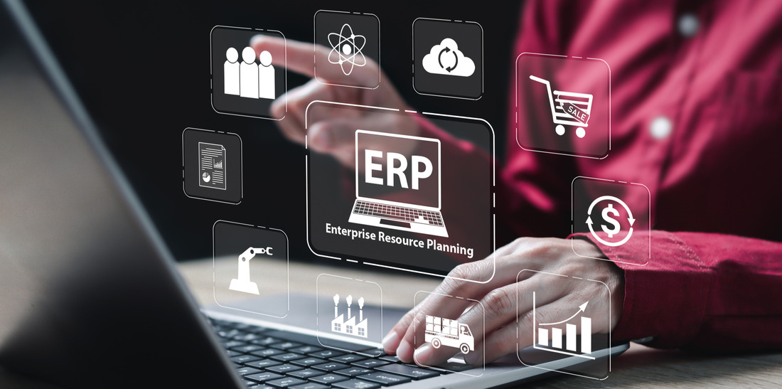 The Power of Streamlined ERP Integration in B2B Ecommerce Professional interacting with virtual ERP interface on laptop, signifying success with ROC Commerce platform for B2B ecommerce